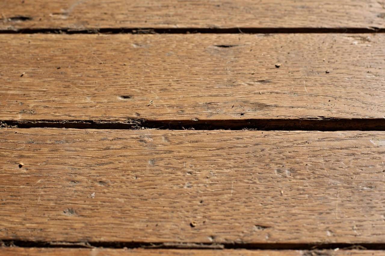 Close-up of hardwood floor boards with visible gaps