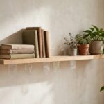 How to Hang Shelves Without Drilling (Renter-Friendly Methods) Floating shelf mounted with adhesive strips holding books and plants