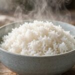 How to Make Perfect Rice Every Single Time (No More Mush) Fluffy white rice in a bowl with steam rising