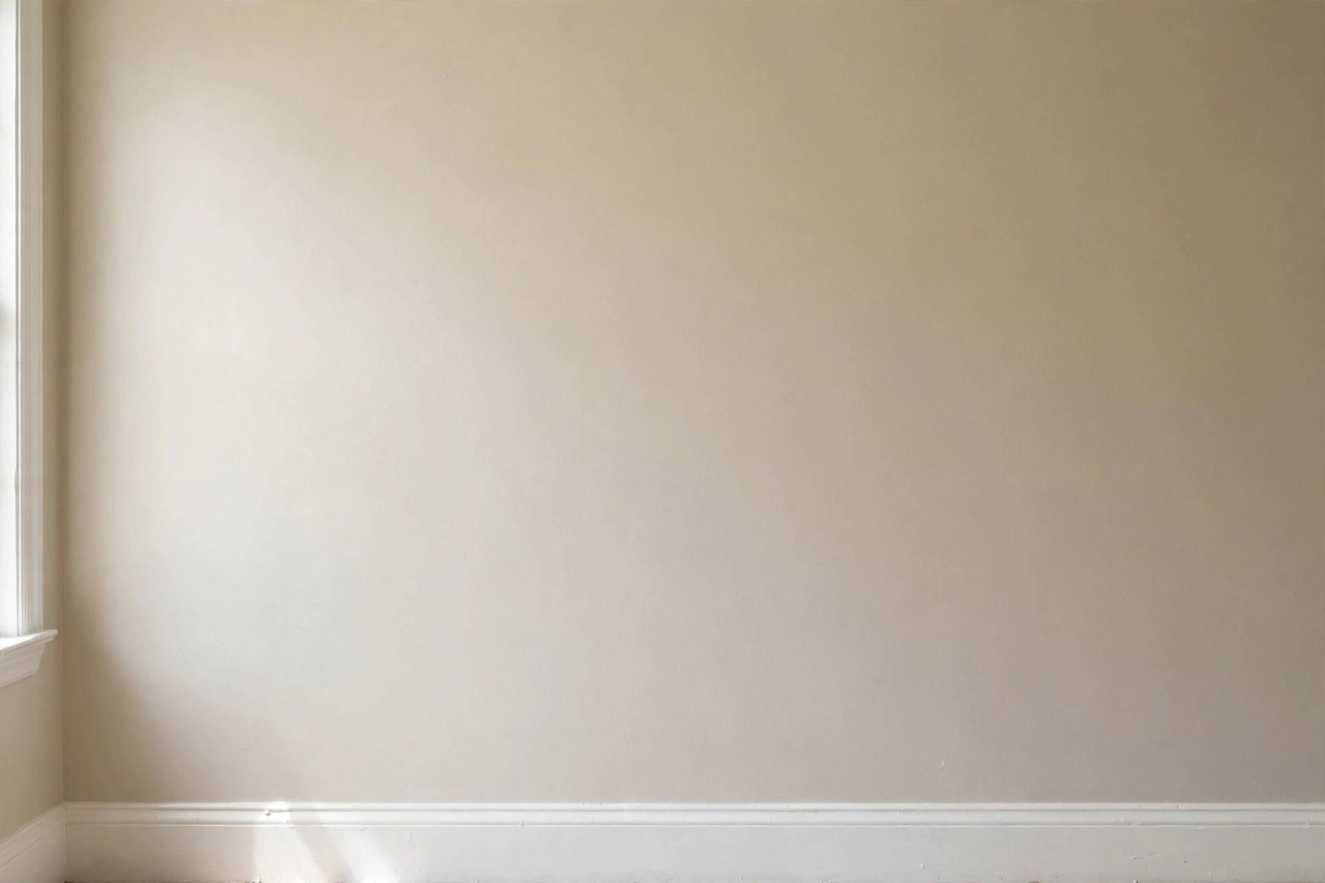 Sanding a dried drywall patch smooth before painting