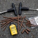 How to Patch a Tire Puncture With a Plug Kit Tire plug kit tools laid out for how to patch a tire puncture plug kit