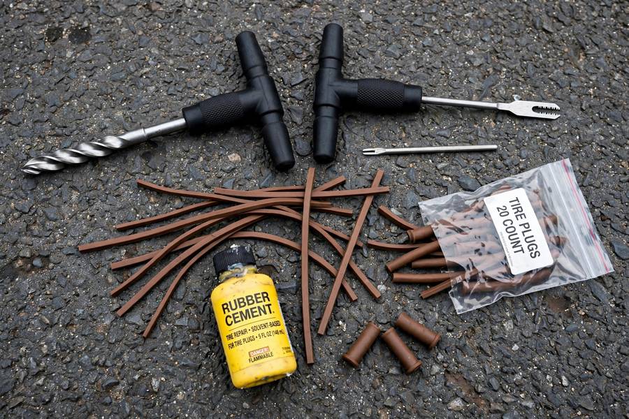 Tire plug kit tools laid out for how to patch a tire puncture plug kit