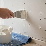 How to Patch Drywall Holes Fast: Quick Fixes for Every Size Filling nail holes in drywall with spackle before painting