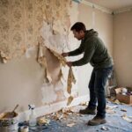 How to Remove Wallpaper Easily: The Pro Method That Works DIY homeowner removing old wallpaper during a room renovation