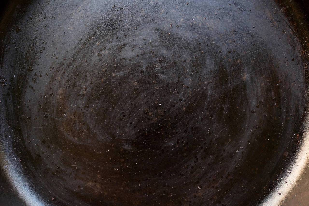 Close-up of smooth seasoned cast iron cooking surface