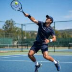 How to Serve a Tennis Ball: The Serve Mechanics Behind Free Points Tennis player demonstrating how to serve a tennis ball with proper toss and contact