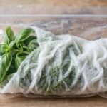 How to Store Fresh Herbs So They Last Weeks, Not Days Basil leaves wrapped in damp paper towel inside a storage bag