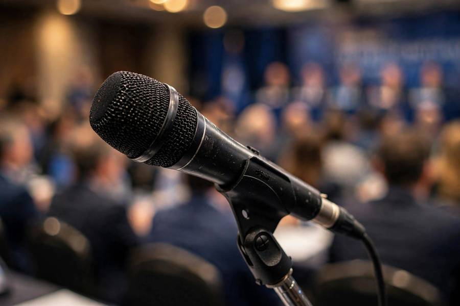 Conference stage microphone, representing rehearsal and delivery when using AI for presentations