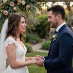 How to Write Your Own Wedding Vows: A Step-by-Step Guide Bride and groom exchanging personal wedding vows outdoors