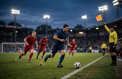 Striker caught in an offside position as the assistant referee raises the flag — offside rule soccer