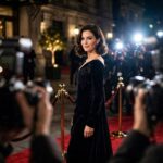 What Is a Celebrity Endorsement? Deals, Costs, Examples Celebrity posing on a red carpet before camera flashes at a premiere event