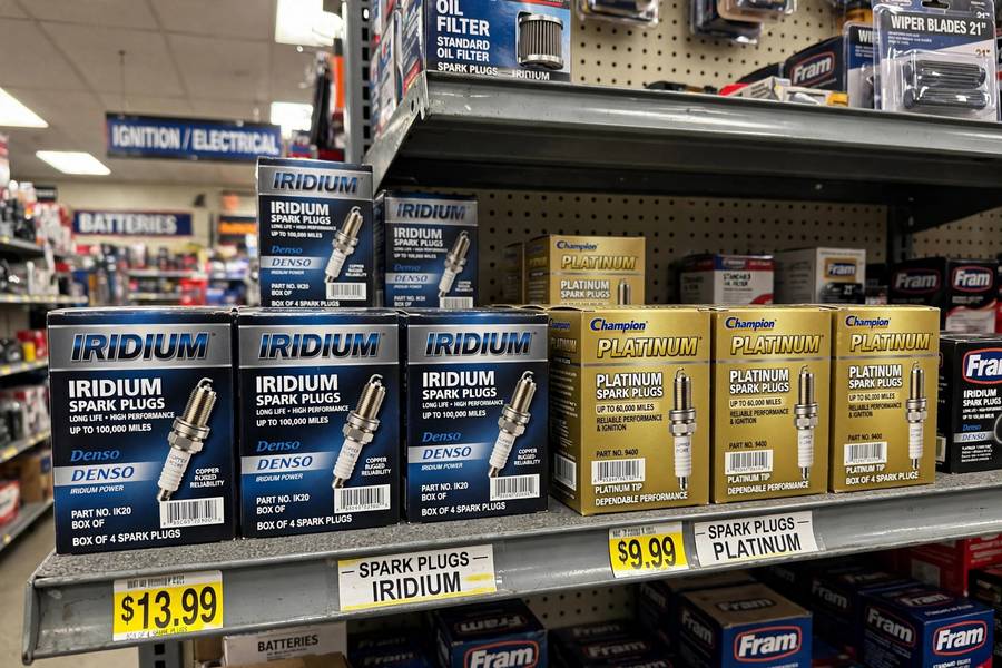 Iridium and platinum spark plug options on a store shelf for the iridium vs platinum spark plugs decision