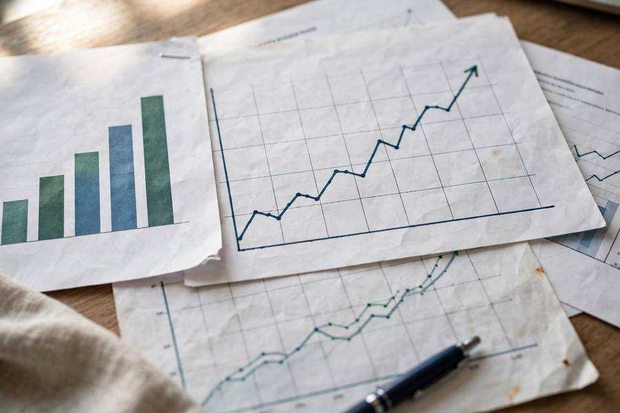 Close-up of financial documents with rising profit graphs