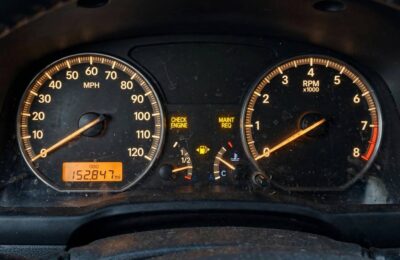 High-mileage car odometer showing over 150,000 miles