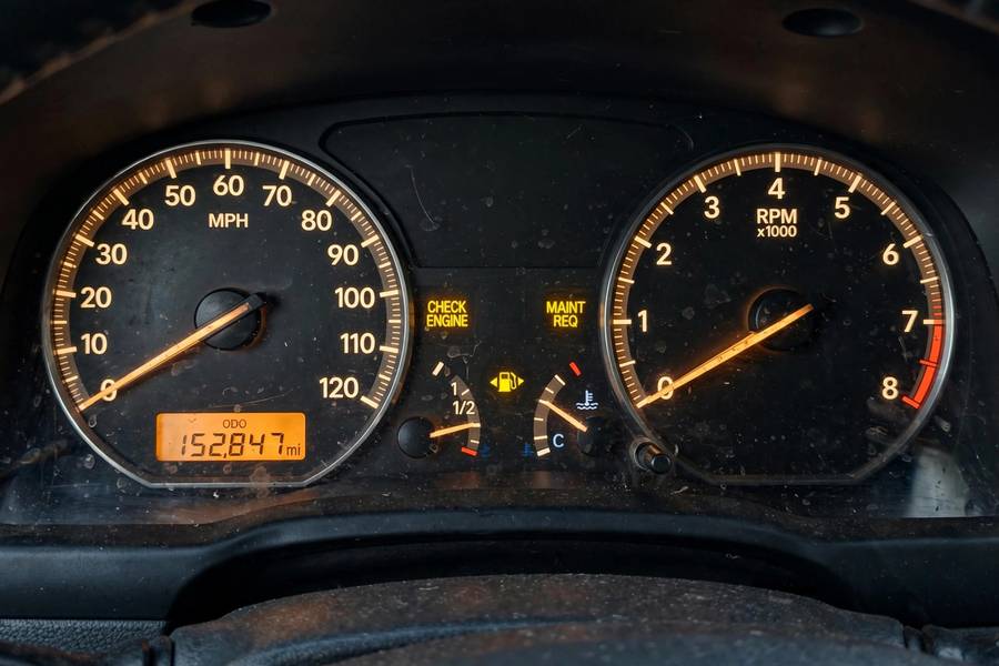 High-mileage car odometer showing over 150,000 miles