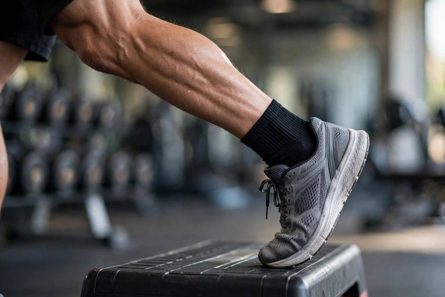 Close-up of calf raise exercise on a step