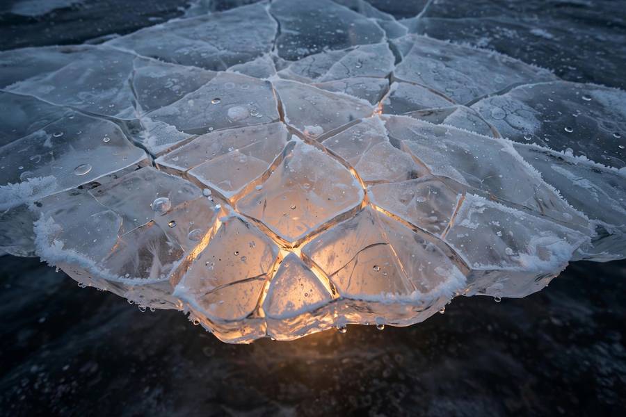 Cracks in the ice representing lessons from the AI winter thawing into spring