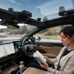 Level 3 Autonomy Cars: What's Actually on the Road Driver reading a book in a Level 3 autonomy car while the vehicle drives itself