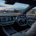 Driver with hands off the wheel illustrating levels of autonomy in self-driving cars