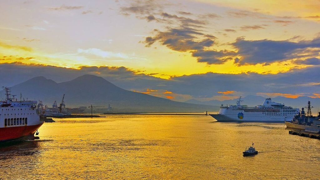 Mount Vesuvius watching over the harbour of Naples, Italy, at dawn, with ships in the bay