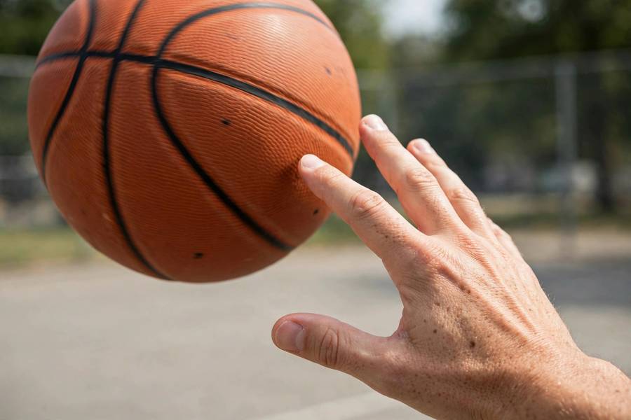 Photorealistic close-up of perfect one-hand release with clean backspin, ball leaving fingertips
