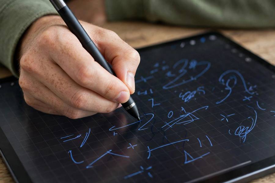 Student handwriting equations with stylus in notes app