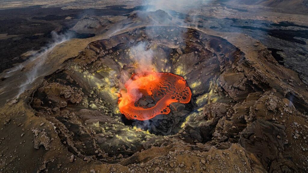 Volcano crater with a glowing lava lake seen from above