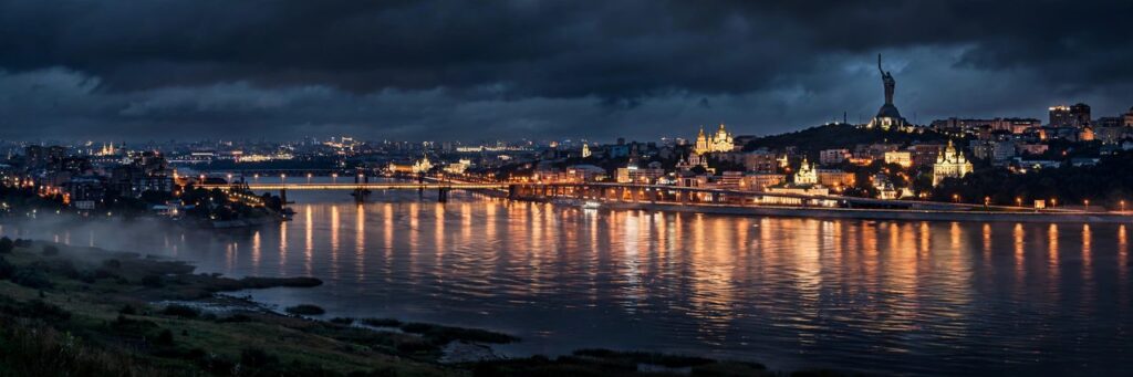 A night view of Kyiv's skyline with city lights, illustrating the stakes of the Russia-Ukraine energy ceasefire