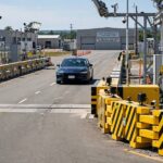 Self Driving Car Deaths: What the Data Actually Shows Car approaching crash test barriers illustrating self driving car deaths safety data