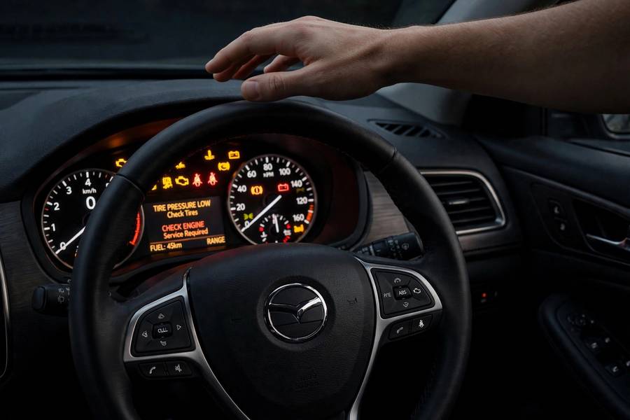 Car dashboard warning lights illustrating self driving cars pros and cons of safety