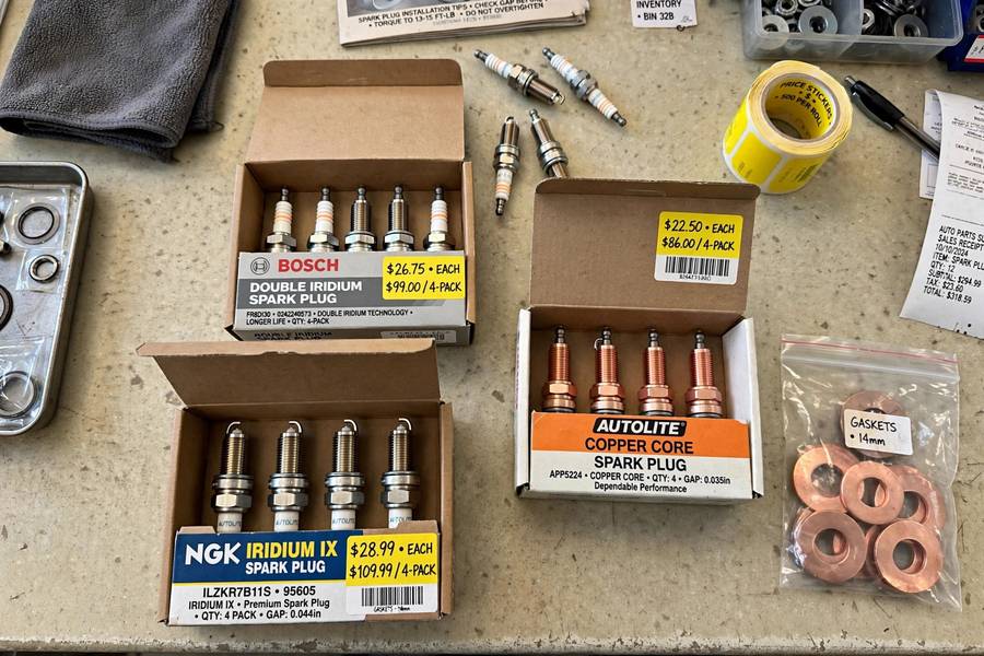 New spark plugs with price tags showing DIY parts cost