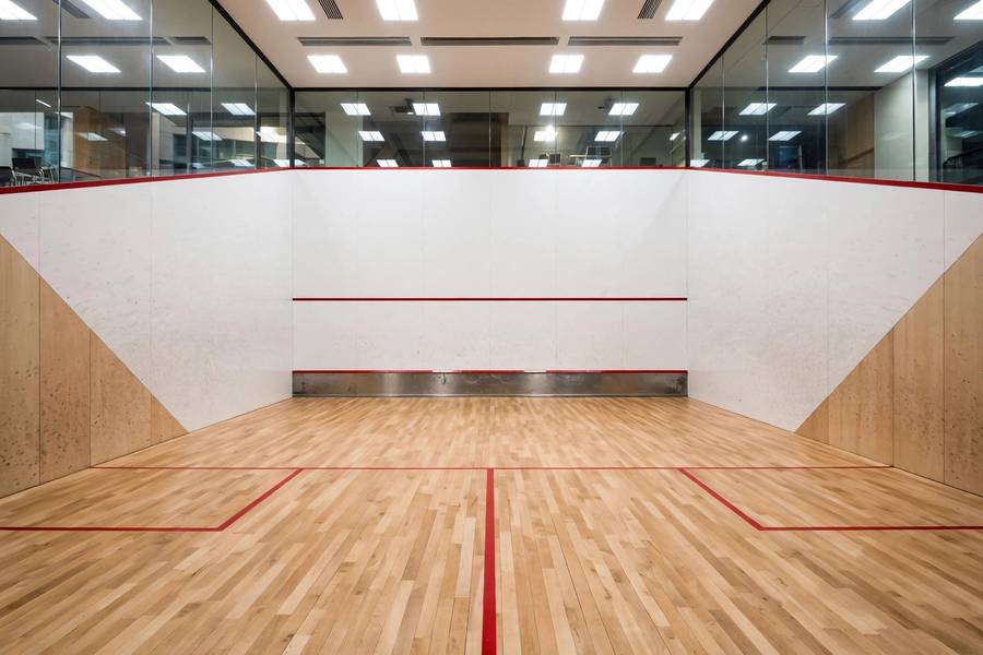 Interior of a standard squash court showing official dimensions, front wall, and floor markings