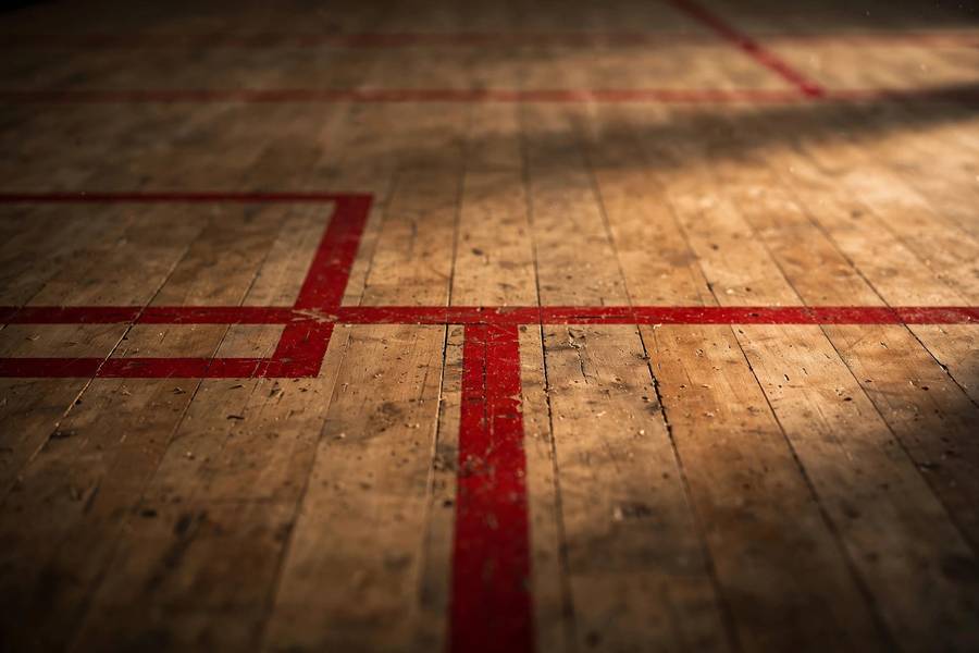 Close-up of squash court floor markings including service boxes and the center T