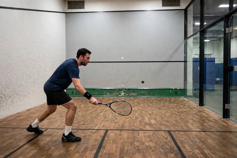 Photorealistic photo of a player practicing low attacking shots targeting just above the tin