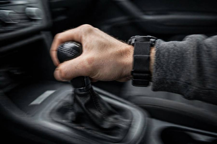 Driver's hand on a gear shifter during rough shifting