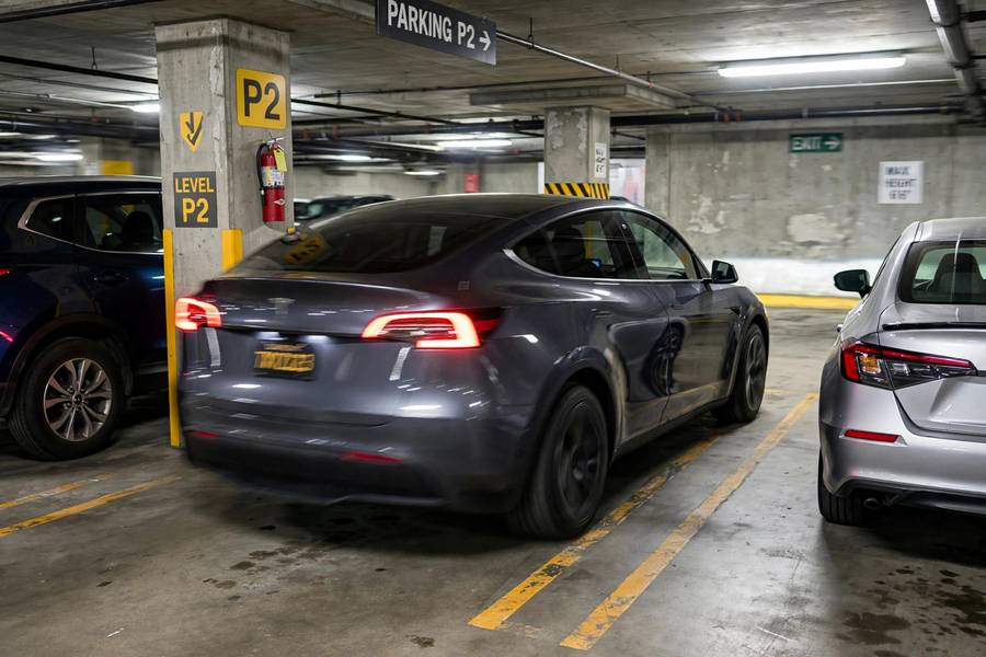 Tesla Autopark maneuvering into a tight perpendicular parking spot
