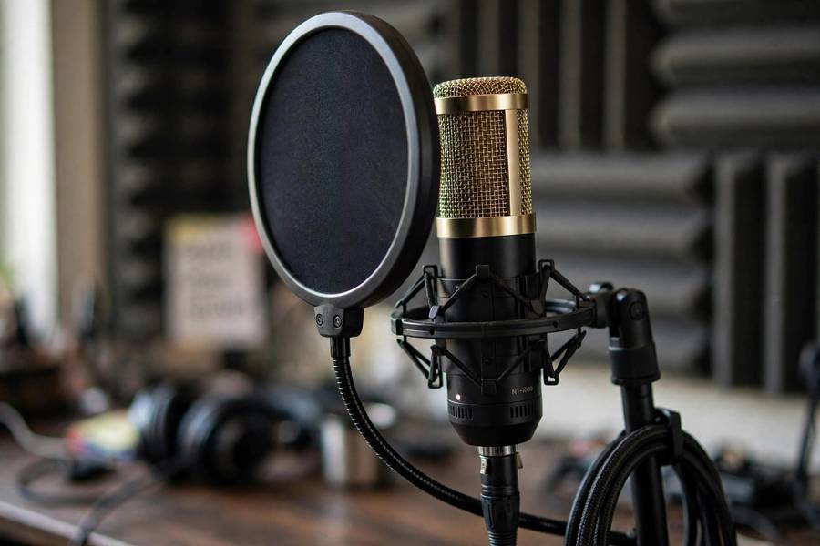 Professional microphone in a home podcast studio using AI voice production