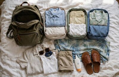 A Thailand packing list laid out — light clothes, packing cubes, sunscreen, and a versatile sarong