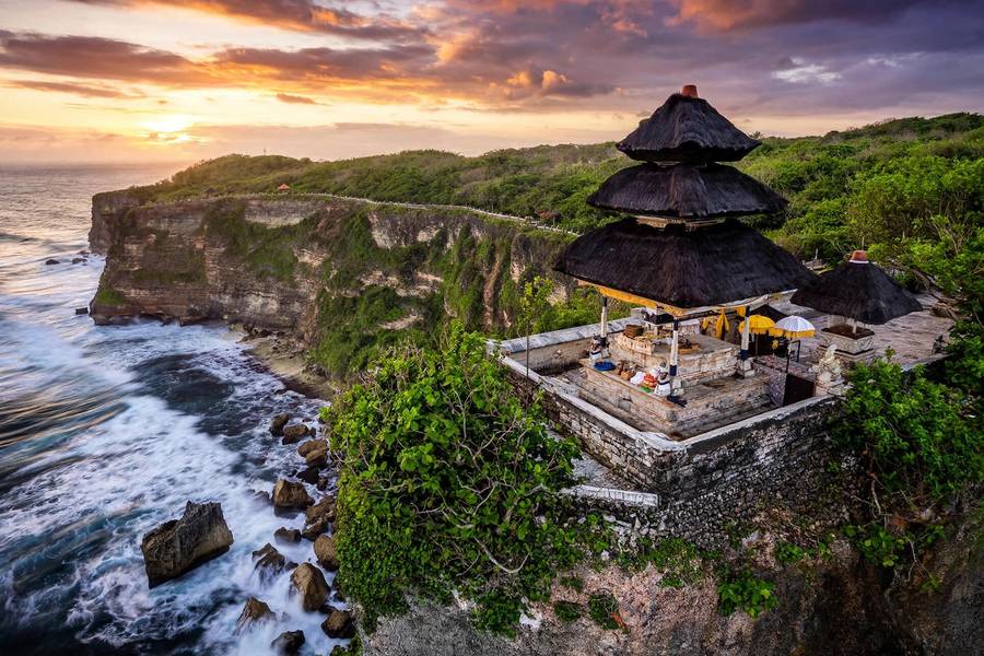 Uluwatu Temple on a cliff at sunset, one of the essential things to do in Bali