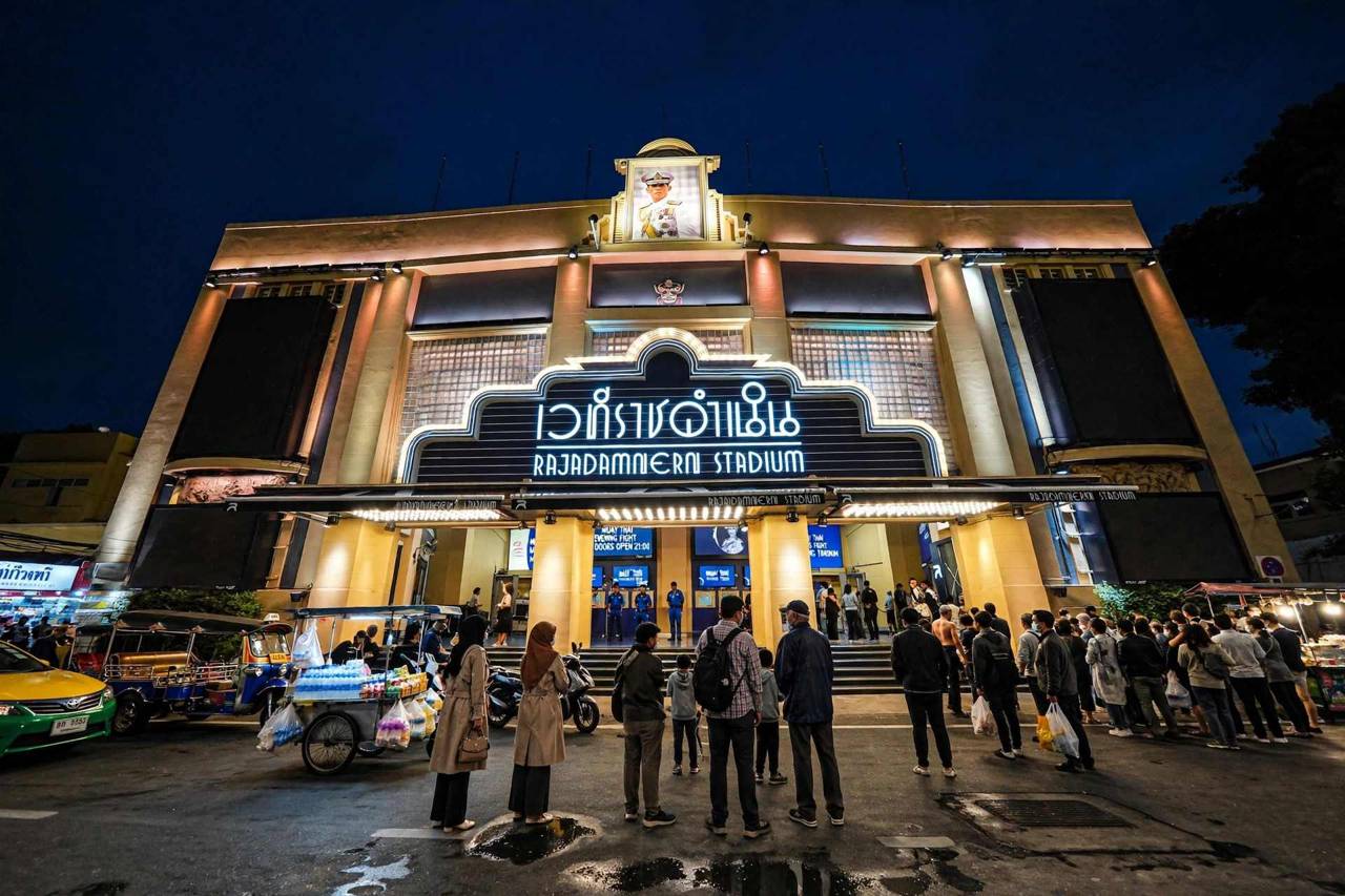 Muay Thai boxing stadium in Bangkok lit up during an evening fight