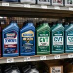 Different transmission fluid types on a store shelf with Dexron, Mercon, and CVT labels