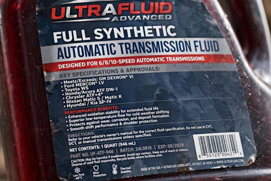 Close-up of a transmission fluid bottle label showing fluid specifications