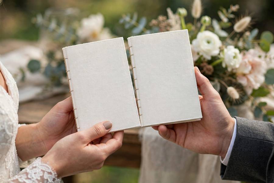 Hands holding vow books