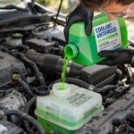 What Does Coolant Do in a Car? A Mechanic Explains Cooling Adding coolant to the reservoir, illustrating what does coolant do in a car