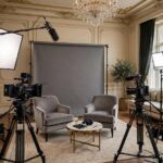 Luxury hotel suite converted to interview setup, cameras and lights, film backdrop, photorealistic