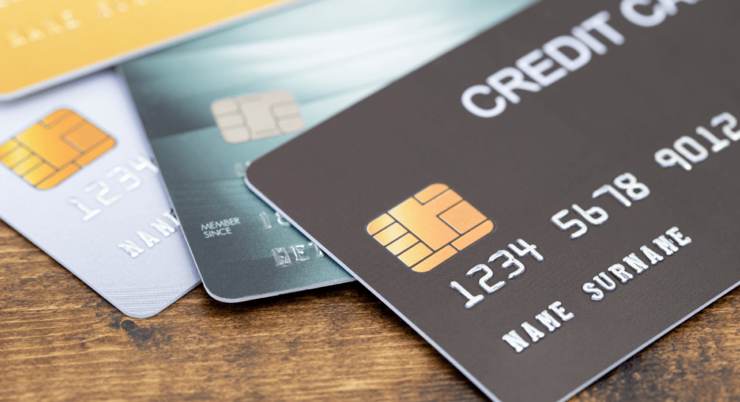 Credit cards fanned out on a wooden desk