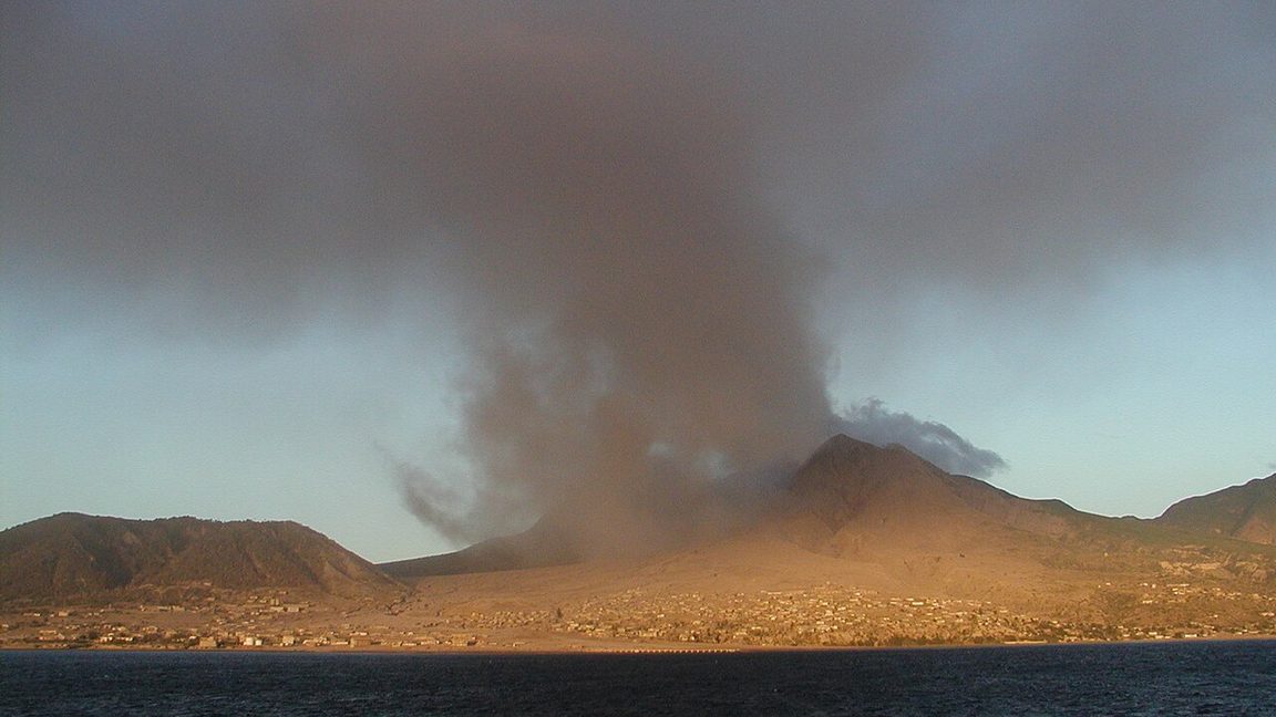 Ash pouring from Soufriere Hills volcano over the abandoned capital Plymouth, Montserrat