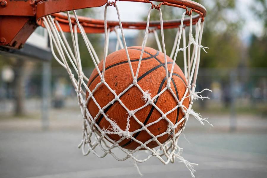 Close-up of a slam dunk with the ball going through the net