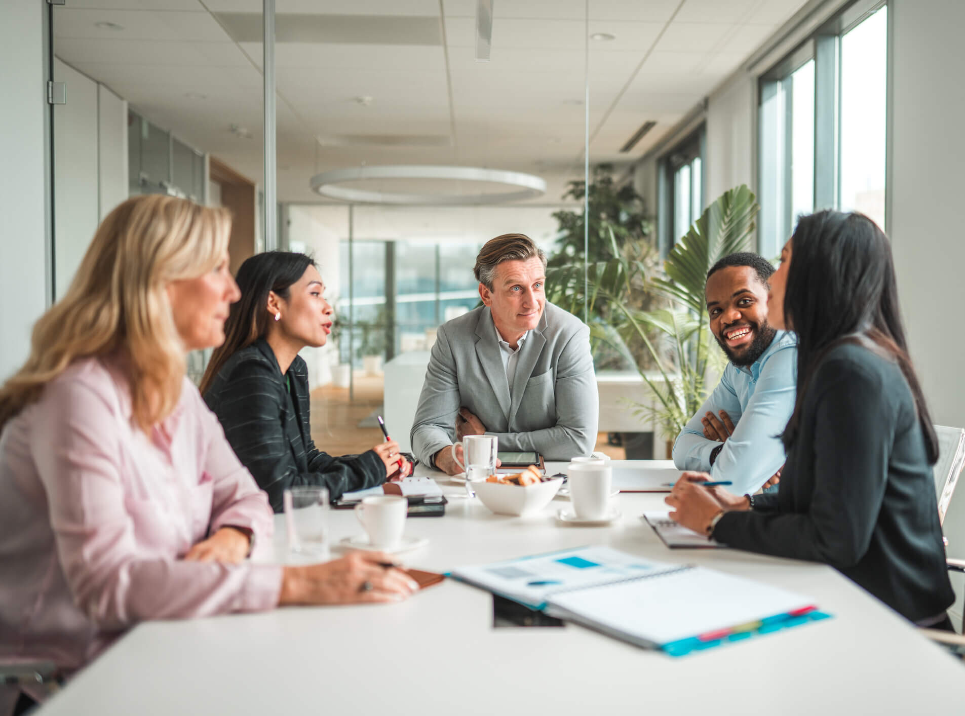 A marketing team discussing strategy around a conference table