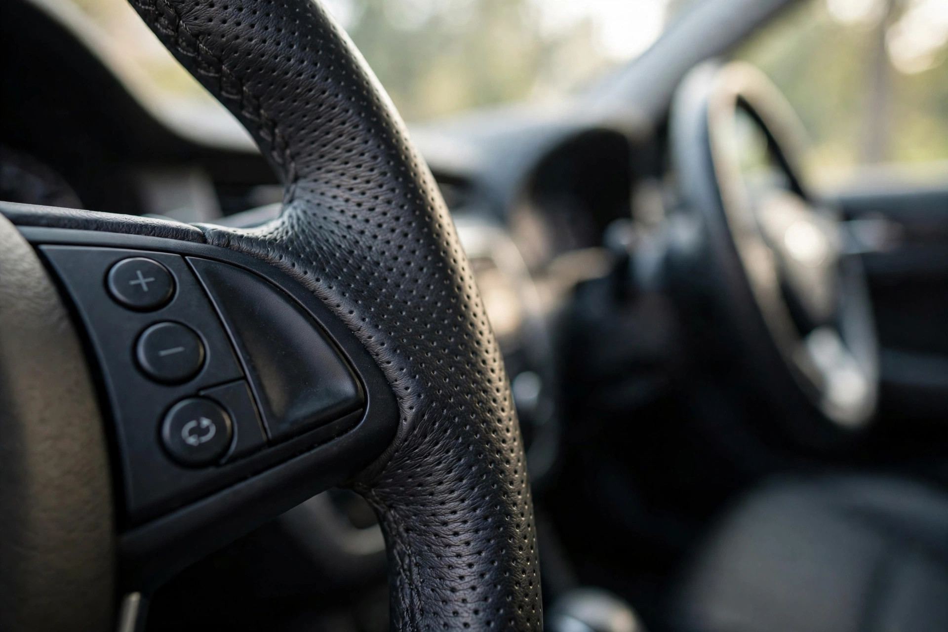 Steering wheel cruise control buttons close-up — what is cruise control